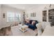 Bright office space with a comfortable blue couch, bookshelves, and natural light at 2636 Nordmann Fir Rd, Raleigh, NC 27616