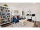 Cozy home office with built-in shelving, comfortable seating, and a functional desk area at 2636 Nordmann Fir Rd, Raleigh, NC 27616