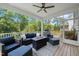 Relaxing screened porch featuring comfortable seating, a ceiling fan, and views of the backyard at 2636 Nordmann Fir Rd, Raleigh, NC 27616
