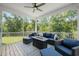 Comfortable screened porch featuring cozy seating, a ceiling fan, and views of the lush greenery at 2636 Nordmann Fir Rd, Raleigh, NC 27616
