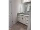 Bright bathroom featuring a granite countertop vanity with black hardware and tile flooring at 269 Hank Way, Angier, NC 27501