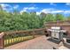 Spacious back deck with a grill and outdoor seating overlooking a wooded area at 2744 Laurelcherry St, Raleigh, NC 27612