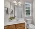 Well-lit bathroom with white walls, a wooden vanity and a bright window at 2744 Laurelcherry St, Raleigh, NC 27612