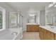 Spacious bathroom with a tub, shower, tile floor and dual sink vanities at 2744 Laurelcherry St, Raleigh, NC 27612