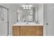 Well lit bathroom with a large mirror above the sink and a glass shower to the left at 2744 Laurelcherry St, Raleigh, NC 27612