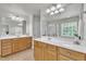 Bright bathroom features double sinks with wooden cabinets, large mirrors, and tile flooring at 2744 Laurelcherry St, Raleigh, NC 27612