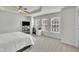 Large bedroom with a ceiling fan, carpeting, and three windows for ample natural light at 2744 Laurelcherry St, Raleigh, NC 27612