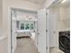 Bedroom view featuring neutral carpet, ceiling fan, and adjacent laundry room at 2744 Laurelcherry St, Raleigh, NC 27612