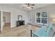 Bedroom with wooden floors, a ceiling fan, a glass door, and a large window at 2744 Laurelcherry St, Raleigh, NC 27612