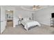 Spacious bedroom with plush carpeting, tray ceiling, and bright natural light at 2744 Laurelcherry St, Raleigh, NC 27612