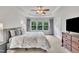 Bright bedroom with a ceiling fan, a dresser, and a large window at 2744 Laurelcherry St, Raleigh, NC 27612
