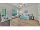 Bedroom with a ceiling fan, a glass door, and a window overlooking the backyard at 2744 Laurelcherry St, Raleigh, NC 27612