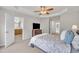 Bedroom showcasing neutral carpet, a ceiling fan, and multiple doorways at 2744 Laurelcherry St, Raleigh, NC 27612