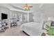 Bright primary bedroom with a ceiling fan, carpeting, and three windows at 2744 Laurelcherry St, Raleigh, NC 27612