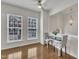 Bright dining area featuring hardwood floors, two large windows, and modern lighting at 2744 Laurelcherry St, Raleigh, NC 27612