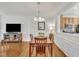 Elegant dining room with hardwood floors, modern lighting, and access to the kitchen at 2744 Laurelcherry St, Raleigh, NC 27612