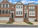 Charming brick townhomes featuring attached garages, lovely architectural details, and well-manicured landscaping at 2744 Laurelcherry St, Raleigh, NC 27612