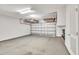Spacious garage with an automatic door, overhead storage racks, and a clean epoxy floor, providing ample parking and storage at 2744 Laurelcherry St, Raleigh, NC 27612