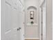 Hallway with hardwood floors, white trim, and convenient storage closet at 2744 Laurelcherry St, Raleigh, NC 27612