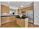 Bright kitchen featuring wood cabinets, stainless steel appliances and center island with black counter at 2744 Laurelcherry St, Raleigh, NC 27612