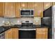 This home's kitchen has stainless steel appliances, wooden cabinets, and black countertops at 2744 Laurelcherry St, Raleigh, NC 27612
