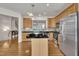 Kitchen features wood cabinets, stainless steel appliances and a center island with black countertop at 2744 Laurelcherry St, Raleigh, NC 27612
