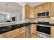 Kitchen featuring wooden cabinets, stainless steel appliances, and granite countertops with backsplash at 2744 Laurelcherry St, Raleigh, NC 27612