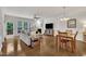 Open living room and dining area features hardwood floors, fireplace, and modern furnishings at 2744 Laurelcherry St, Raleigh, NC 27612