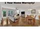 Bright living room featuring hardwood floors, a fireplace, and large windows that fill the room with natural light at 2744 Laurelcherry St, Raleigh, NC 27612