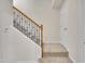 Carpeted staircase with dark metal railing and wooden banister in a home at 2744 Laurelcherry St, Raleigh, NC 27612