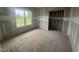 Bedroom featuring a window with a backyard view, neutral walls, and unfinished flooring at 2744 Rains Mill Rd, Princeton, NC 27569
