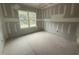 Bedroom features a large window providing natural light, with blank walls ready for customization at 2744 Rains Mill Rd, Princeton, NC 27569