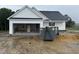 New construction exterior showing attached garage and white siding details on a cloudy day at 2744 Rains Mill Rd, Princeton, NC 27569