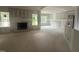 Spacious living room featuring a fireplace, large windows, and neutral walls awaiting personalization at 2744 Rains Mill Rd, Princeton, NC 27569