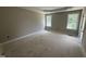 Spacious main bedroom featuring large windows and tray ceiling, offering a bright and airy atmosphere at 2744 Rains Mill Rd, Princeton, NC 27569