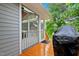 Cozy back porch area featuring a covered grill and convenient access to the screened-in porch at 2805 Friendship Rd, Durham, NC 27705