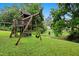 Well-maintained backyard featuring a wooden playset with swings and slide at 2805 Friendship Rd, Durham, NC 27705