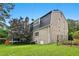 Spacious backyard with lush lawn, mature tree, and classic brick home elevation at 2805 Friendship Rd, Durham, NC 27705