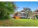 Lush backyard featuring wooden playset and screened porch area; great for outdoor enjoyment at 2805 Friendship Rd, Durham, NC 27705