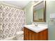 Bathroom with vanity, neutral shower curtain, and a vintage mirror above the sink at 2805 Friendship Rd, Durham, NC 27705