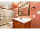 Bathroom with a glass-enclosed shower, a wood vanity, and an updated sink at 2805 Friendship Rd, Durham, NC 27705