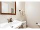 Elegant powder room with pedestal sink, bronze fixtures, and neutral color palette at 2805 Friendship Rd, Durham, NC 27705