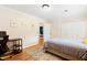 Bright bedroom featuring hardwood floors, closet space, and desk area for working from home at 2805 Friendship Rd, Durham, NC 27705