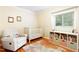 bedroom with a crib, white rocker, and cheerful decor, bathed in natural light at 2805 Friendship Rd, Durham, NC 27705