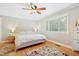 Serene bedroom boasts natural light, neutral colors, hardwood floors, and a ceiling fan at 2805 Friendship Rd, Durham, NC 27705