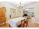 Bright dining room features hardwood floors, neutral paint, with a clear view into the living room at 2805 Friendship Rd, Durham, NC 27705
