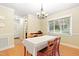 Well-lit dining room features hardwood floors, neutral paint, and traditional chandelier at 2805 Friendship Rd, Durham, NC 27705