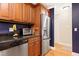 The well-lit kitchen features stainless steel appliances, granite countertops, and wooden cabinets at 2805 Friendship Rd, Durham, NC 27705