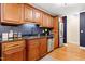 Well-appointed kitchen features granite countertops, stainless steel appliances, and rich wood cabinetry at 2805 Friendship Rd, Durham, NC 27705