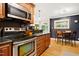 Eat-in kitchen featuring stainless steel appliances, granite countertops and adjacent breakfast nook at 2805 Friendship Rd, Durham, NC 27705